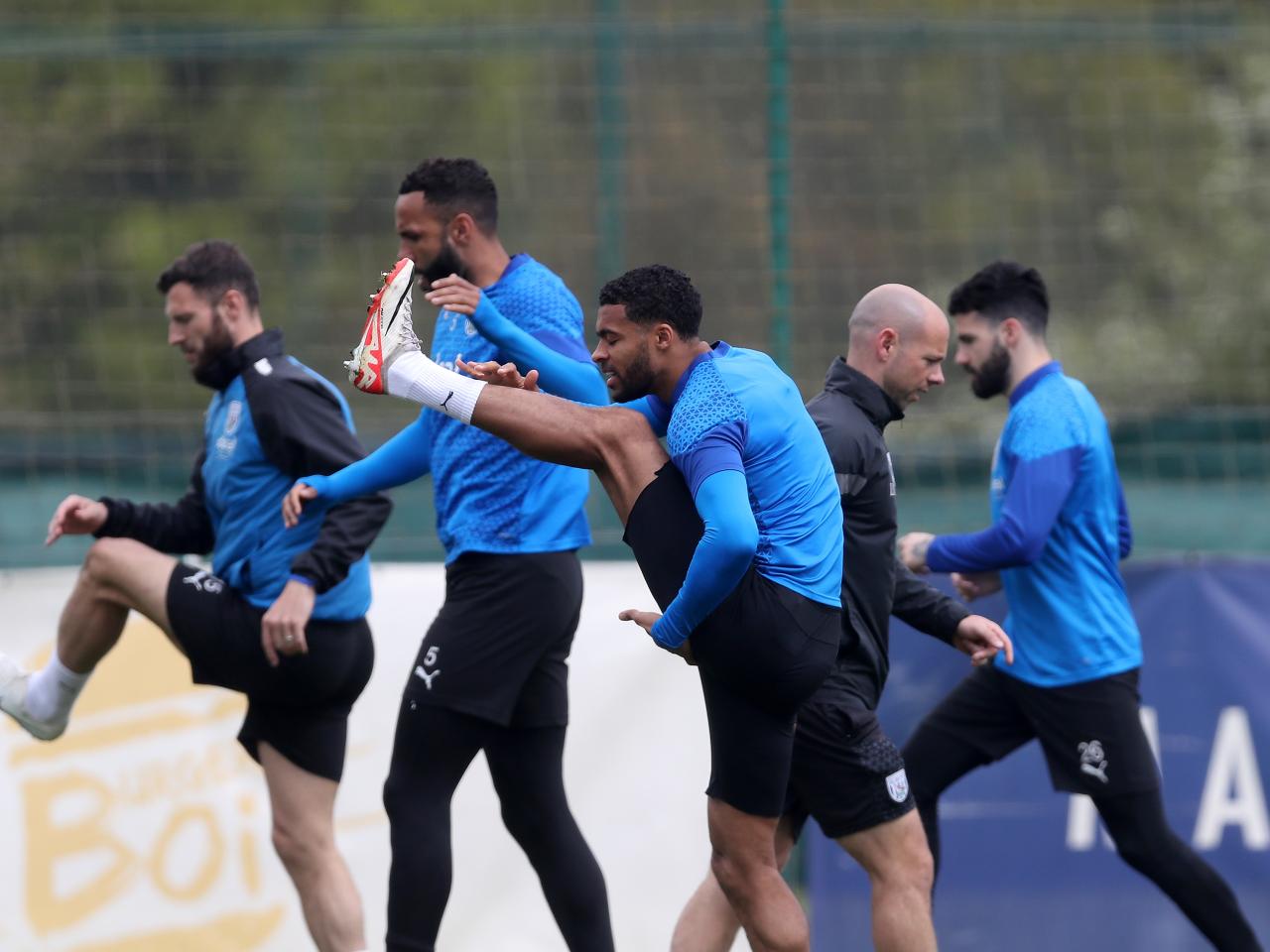 A number of Albion players warm up before a training session