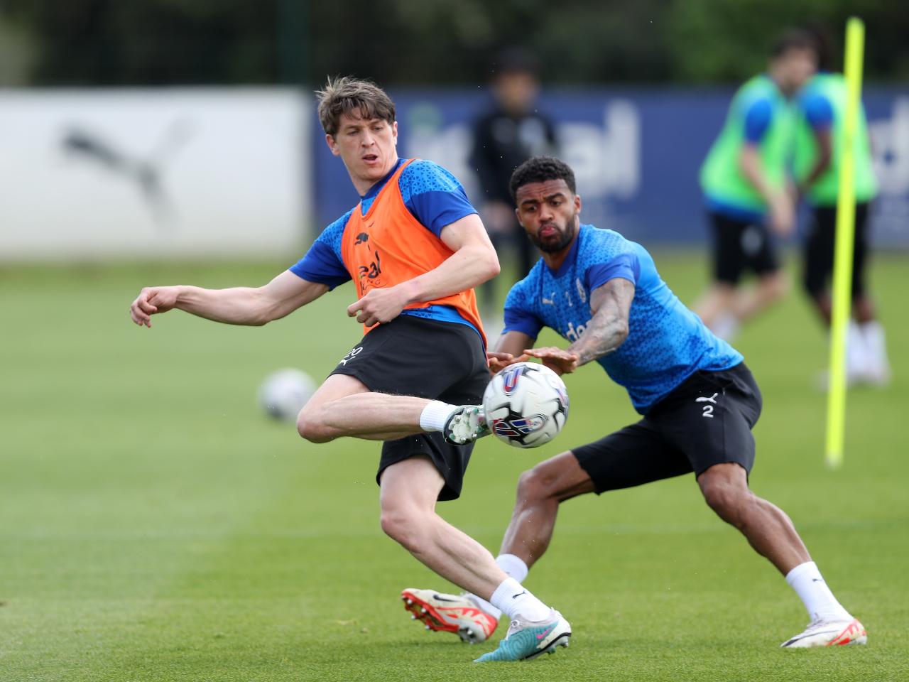 Adam Reach and Darnell Furlong battle for the ball during training 