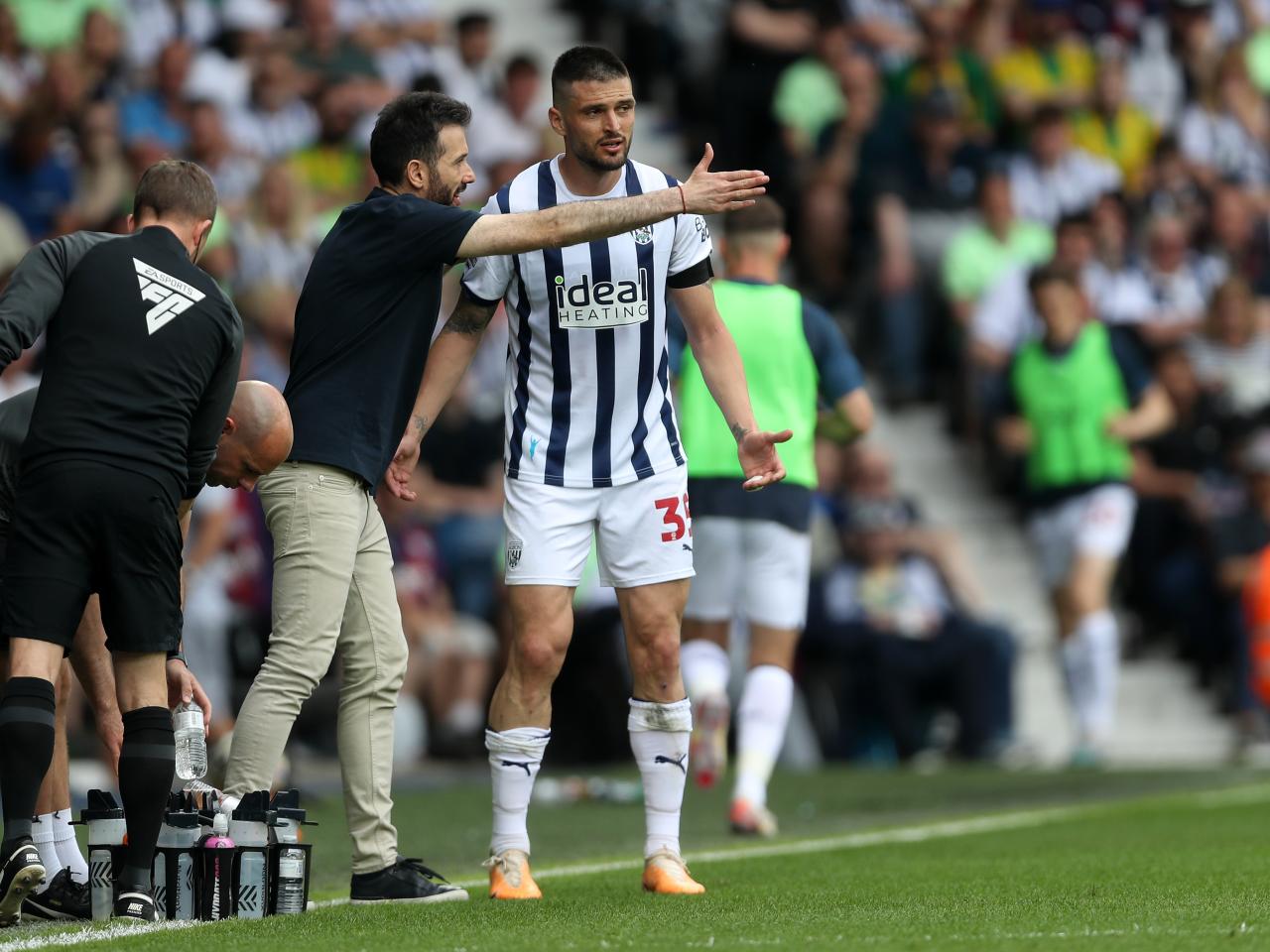 Carlos Corberán delivering a message to Okay Yokuslu on the side of the pitch at The Hawthorns against Southampton 