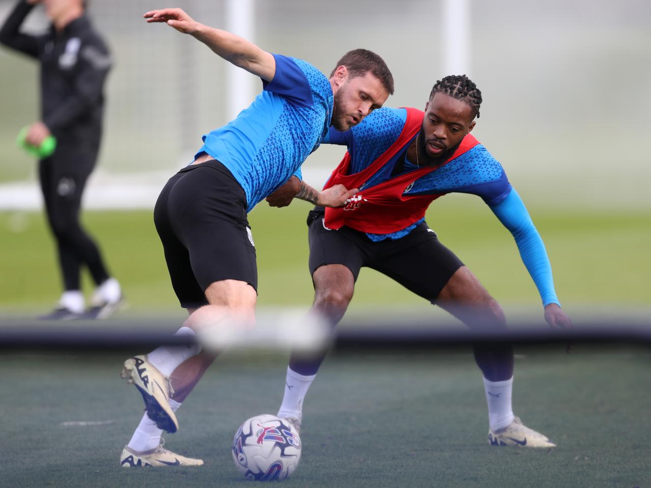 John Swift and Nathaniel Chalobah battle for the ball during training 
