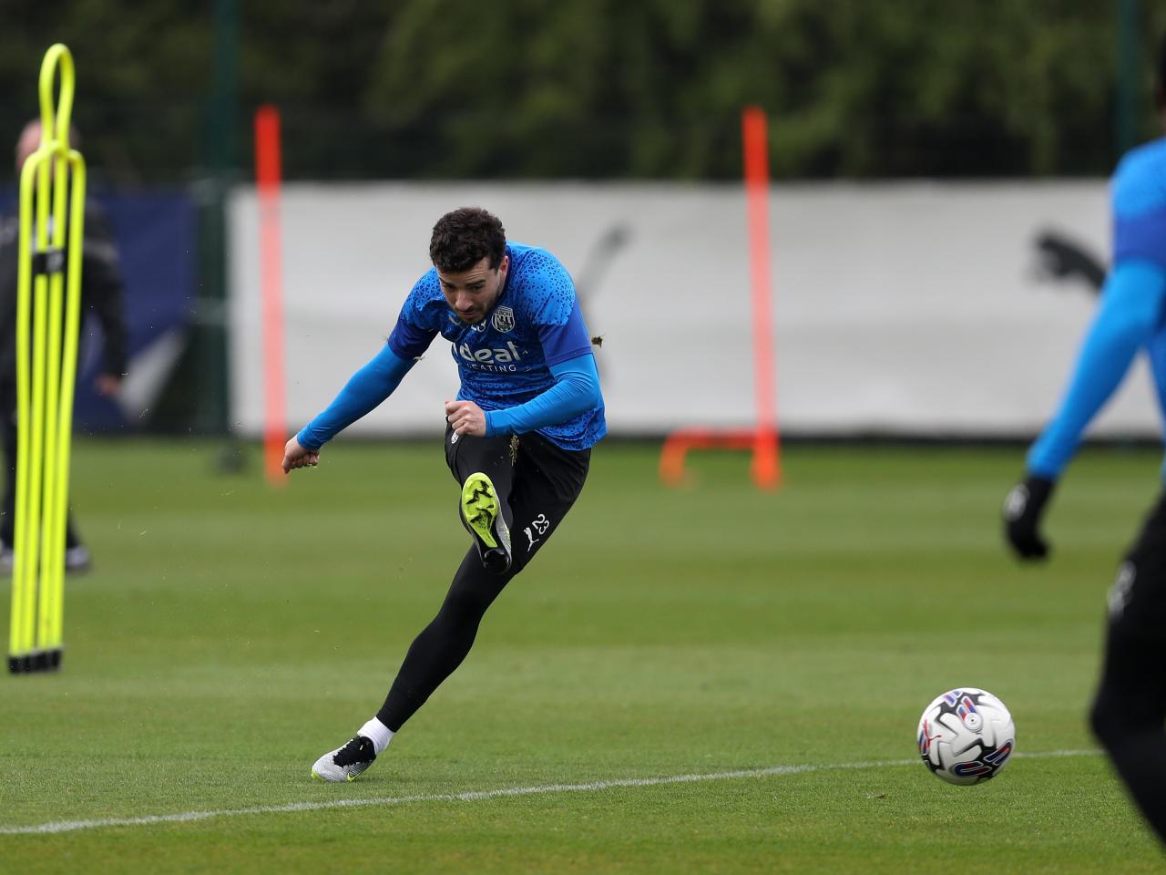Mikey Johnston shooting towards goal during a training session