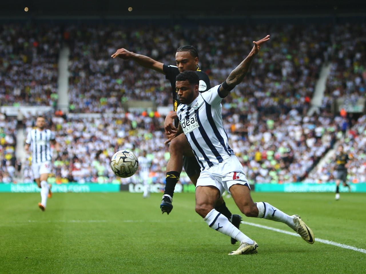 Darnell Furlong fights for the ball against a Southampton player at The Hawthorns 