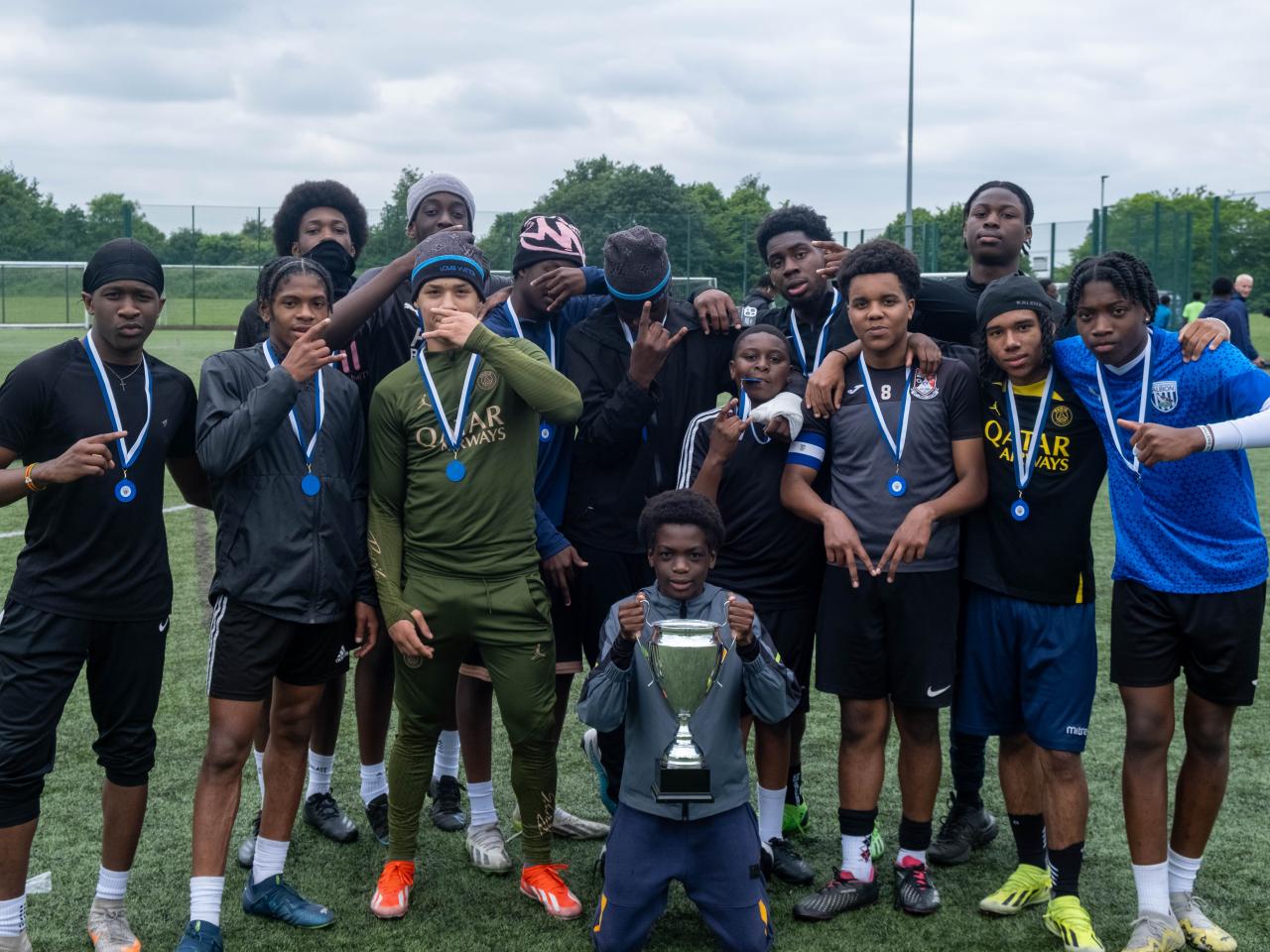 Team photo of winners (Non bibs) with trophy.