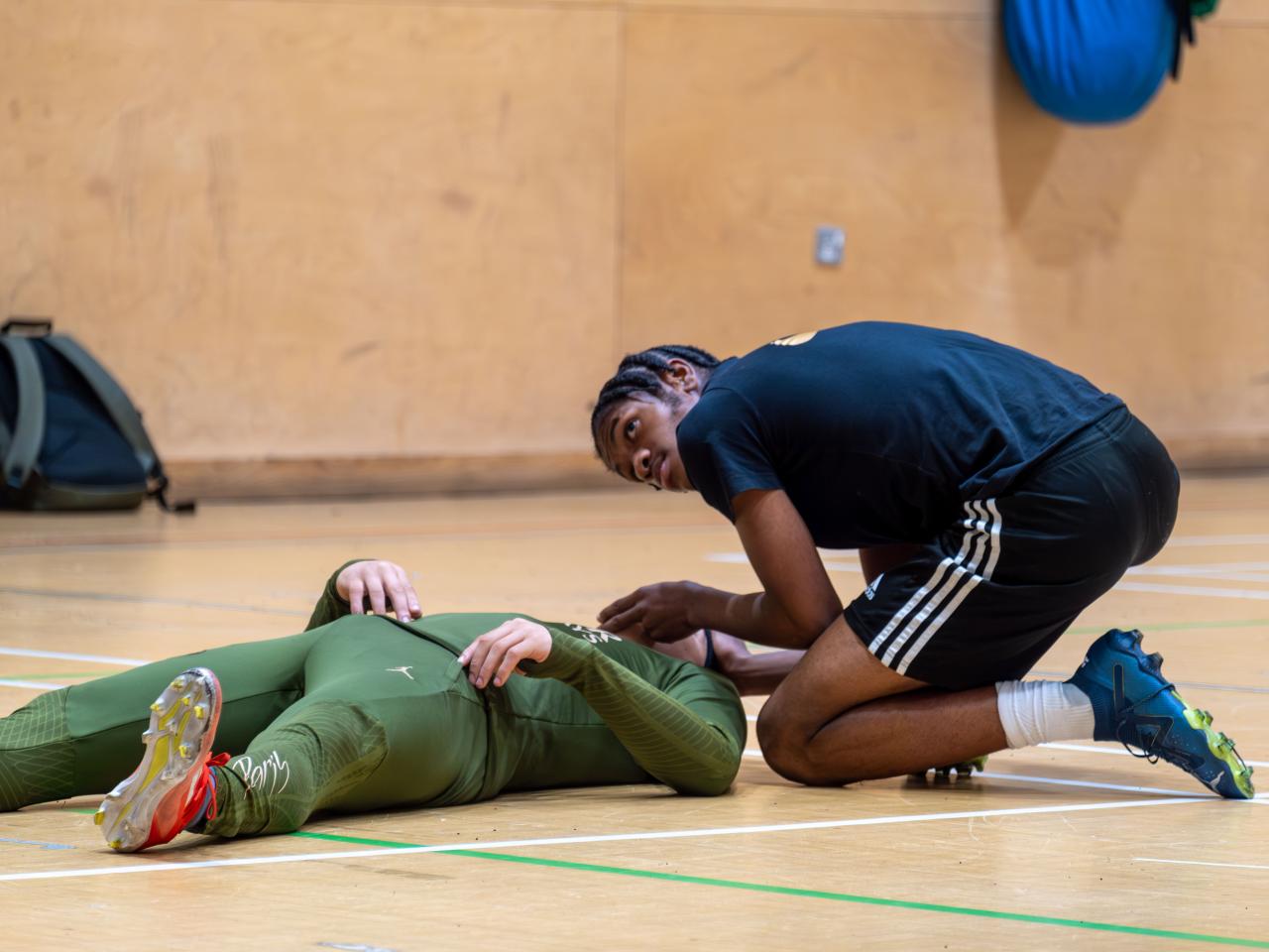 Participant checking vitals during Street First Aid workshop.