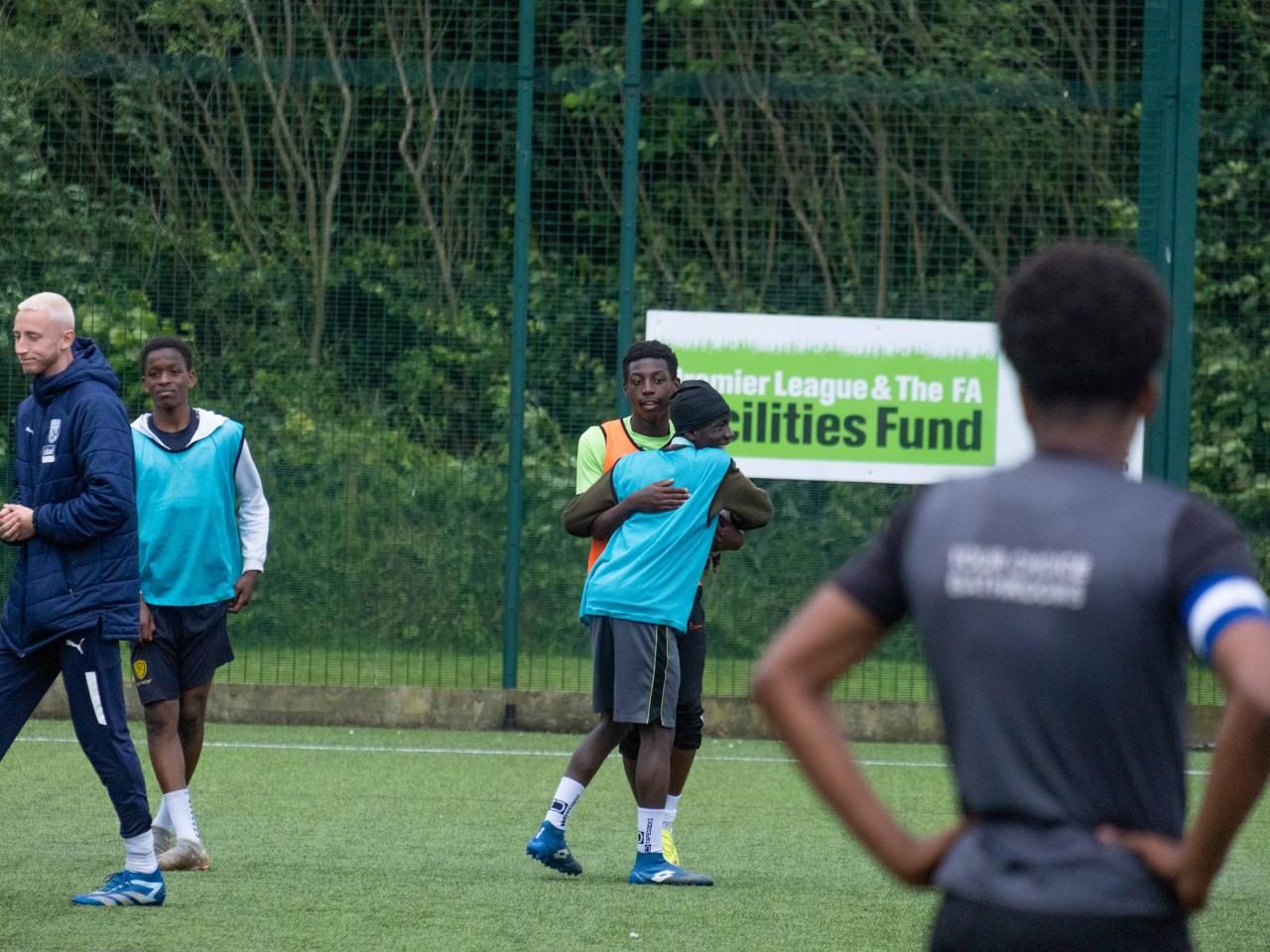 Two players embrace at the end of the game.