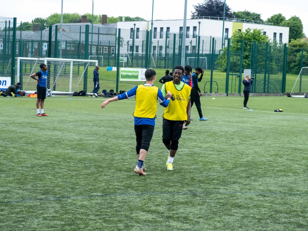 Teammate embrace after the game (yellow bibs)