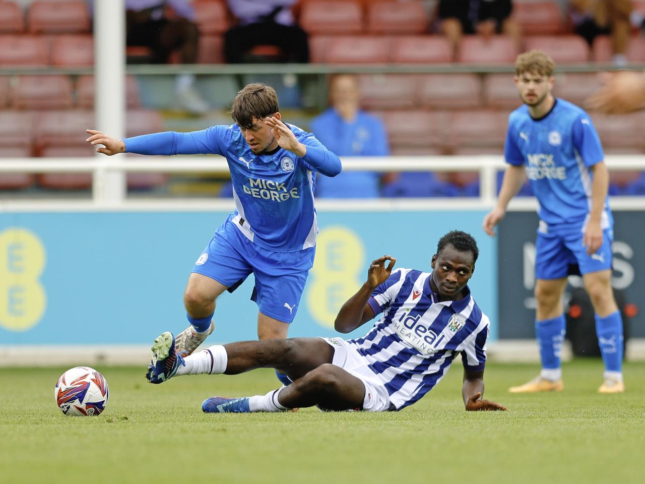 An image of Ousmane Diakite putting in a tackle during Albion's friendly against Peterborough