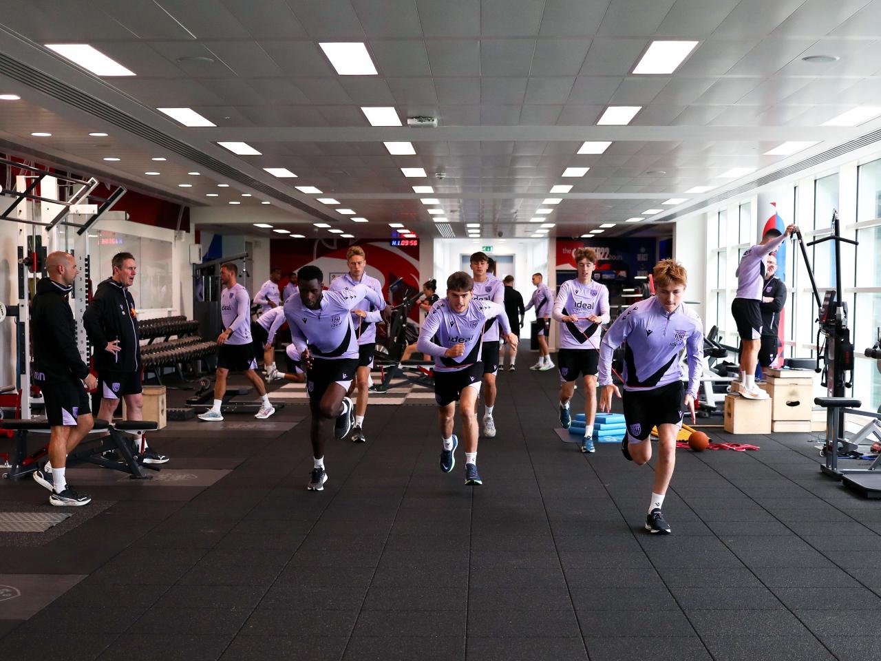 A large group of Albion players working in the gym at St. George's Park