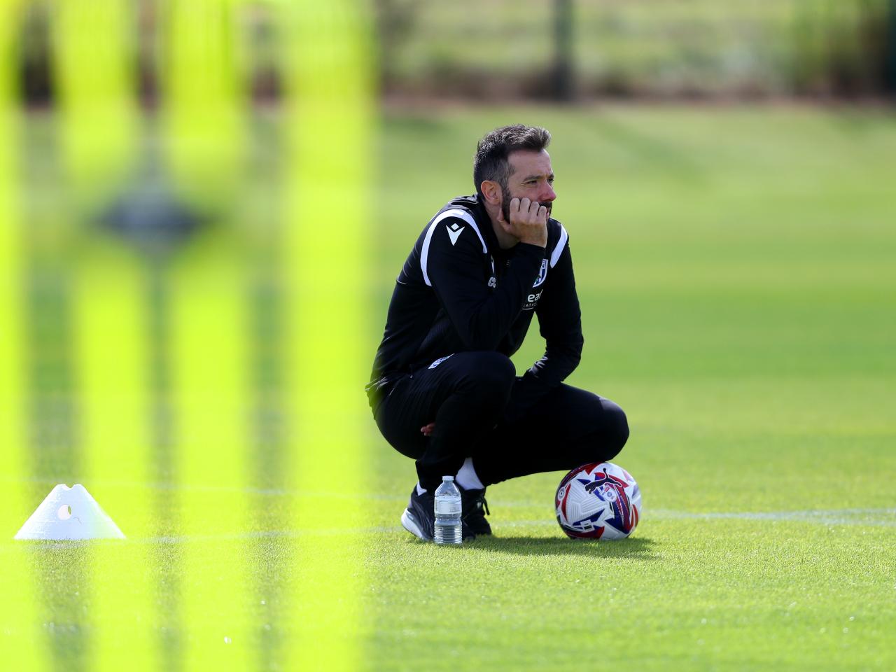 Carlos Corberán watching over a training session 