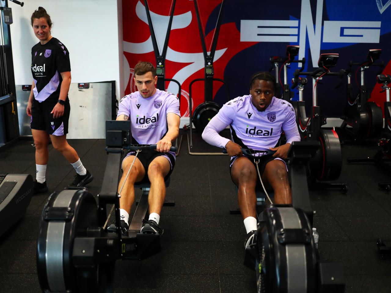 Jayson Molumby and Reyes Cleary on the rowing machine in the gym at St. George's Park