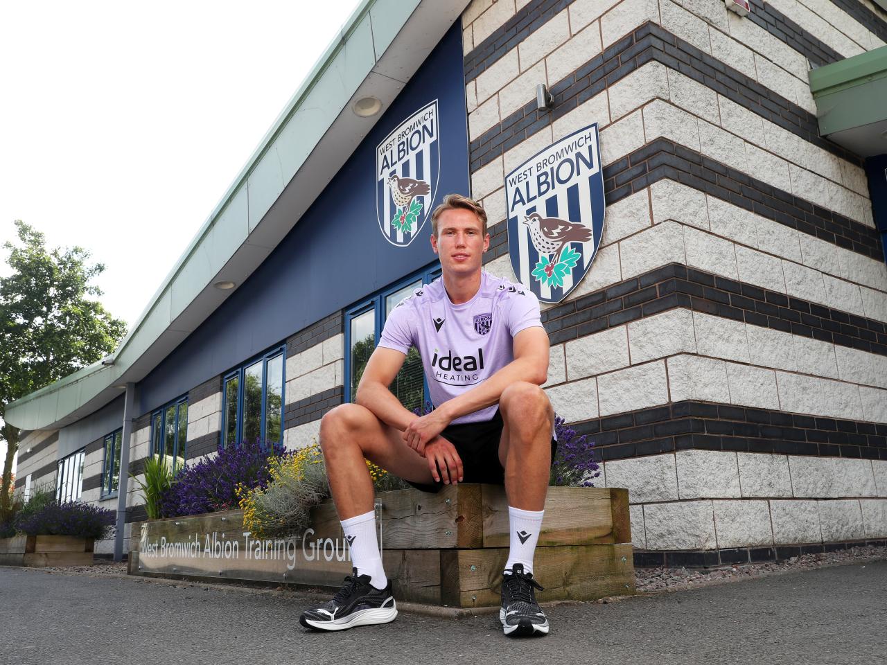 Torbjørn Heggem sat outside the training ground smiling at the camera 