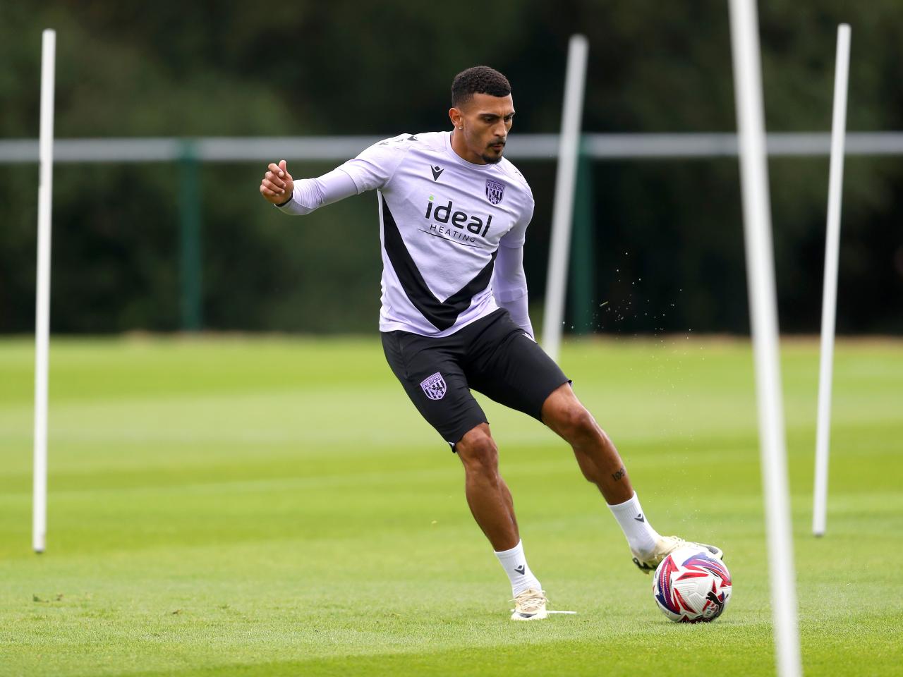 Karlan Grant striking the ball during a training session