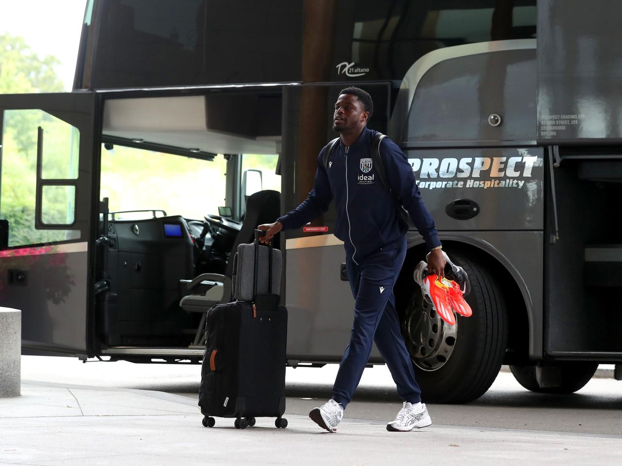Josh Maja arriving at St. George's Park pushing a suitcase 