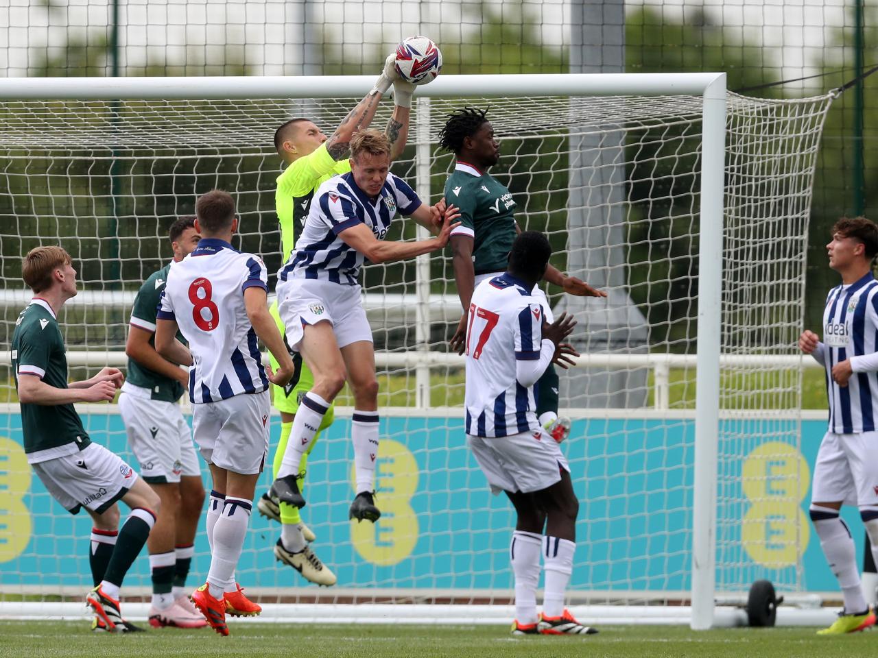 Several players and Albion keeper Ted Cann jump to try and connect with the ball against Bolton 