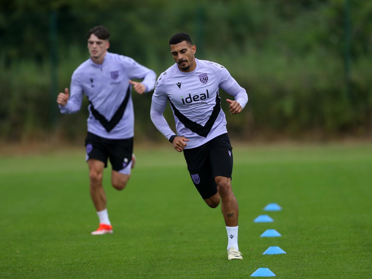 Karlan Grant running during a training session 