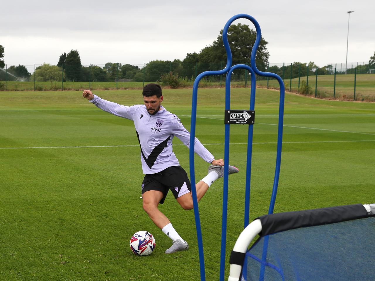 Alex Mowatt striking the ball during a training session 