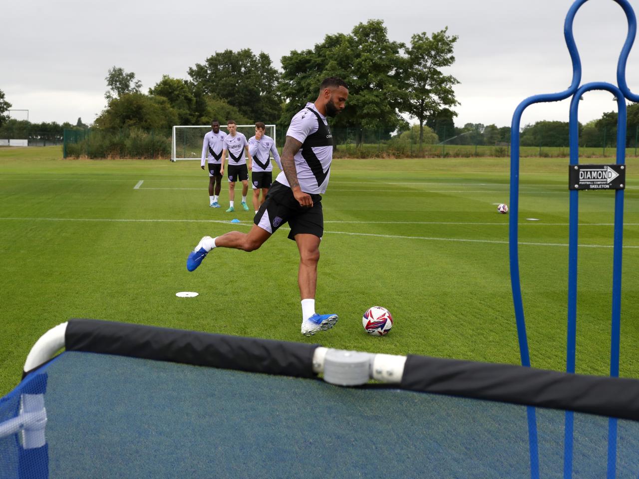 Kyle Bartley passing a ball during a training session 