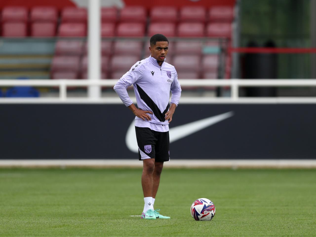 Deago Nelson stood by the ball on the training pitch at St. George's Park