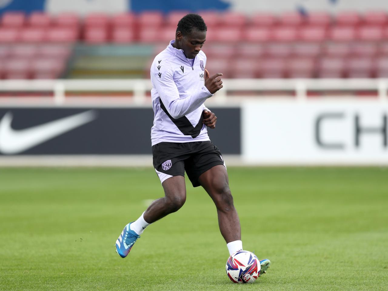 Ousmane Diakité passing a ball during a training session at St. George's Park