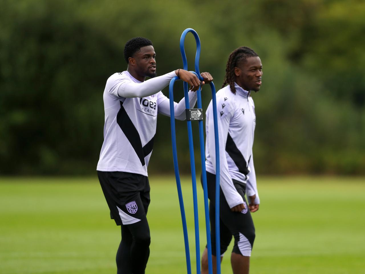 Josh Maja and Brandon Thomas-Asante stood by a mannequin during a training session 