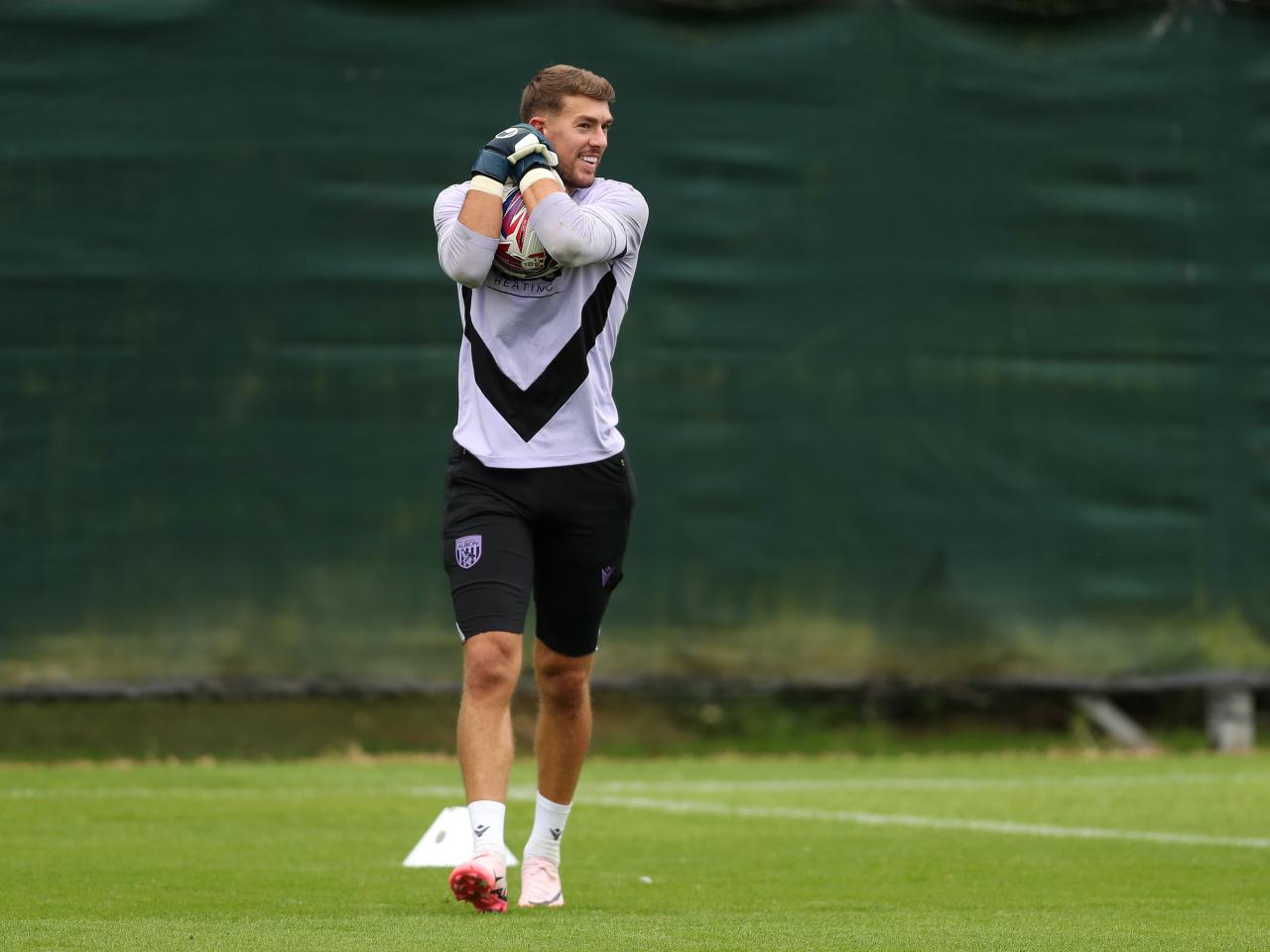 Alex Palmer gripping the ball during a training session 