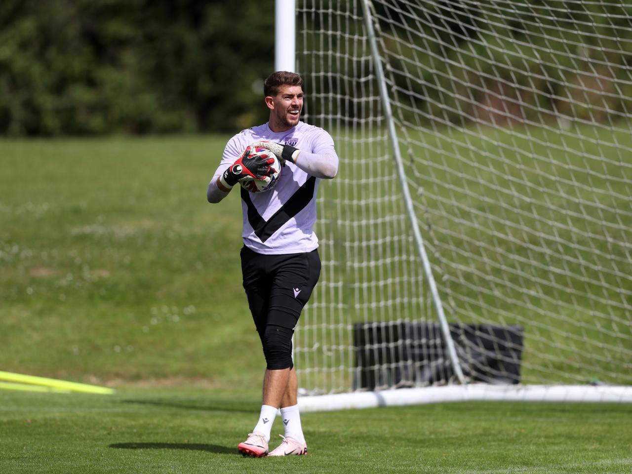 Alex Palmer holding a ball in training 