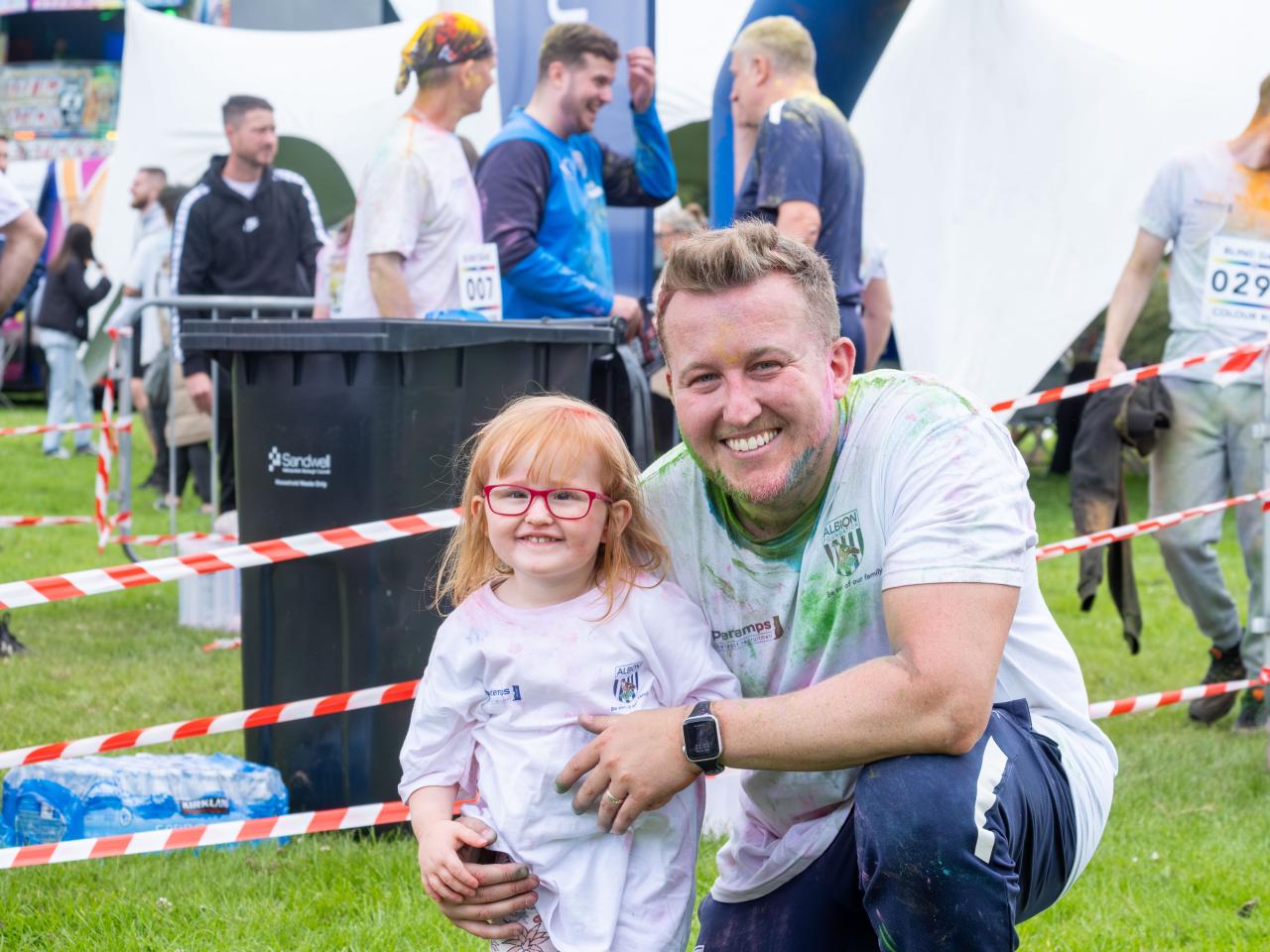 Deputy Director Jonathan Ward (kneeling) and daughter.