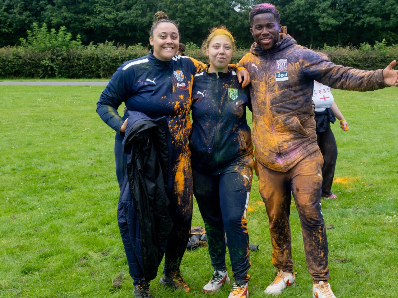 Three Foundation staff members, arm in arm, posing for photo.