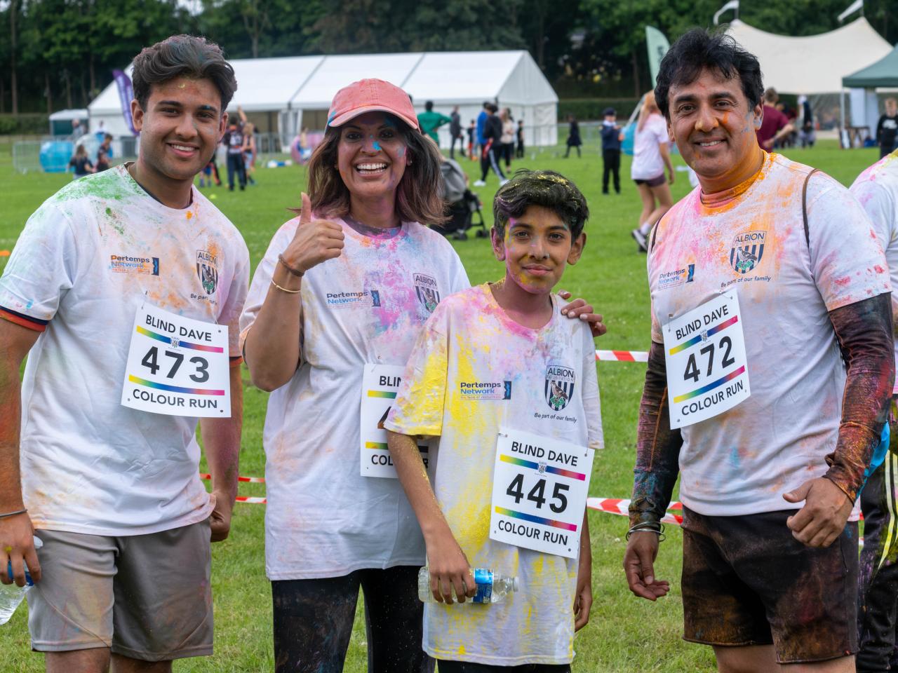 Family of four smiling.