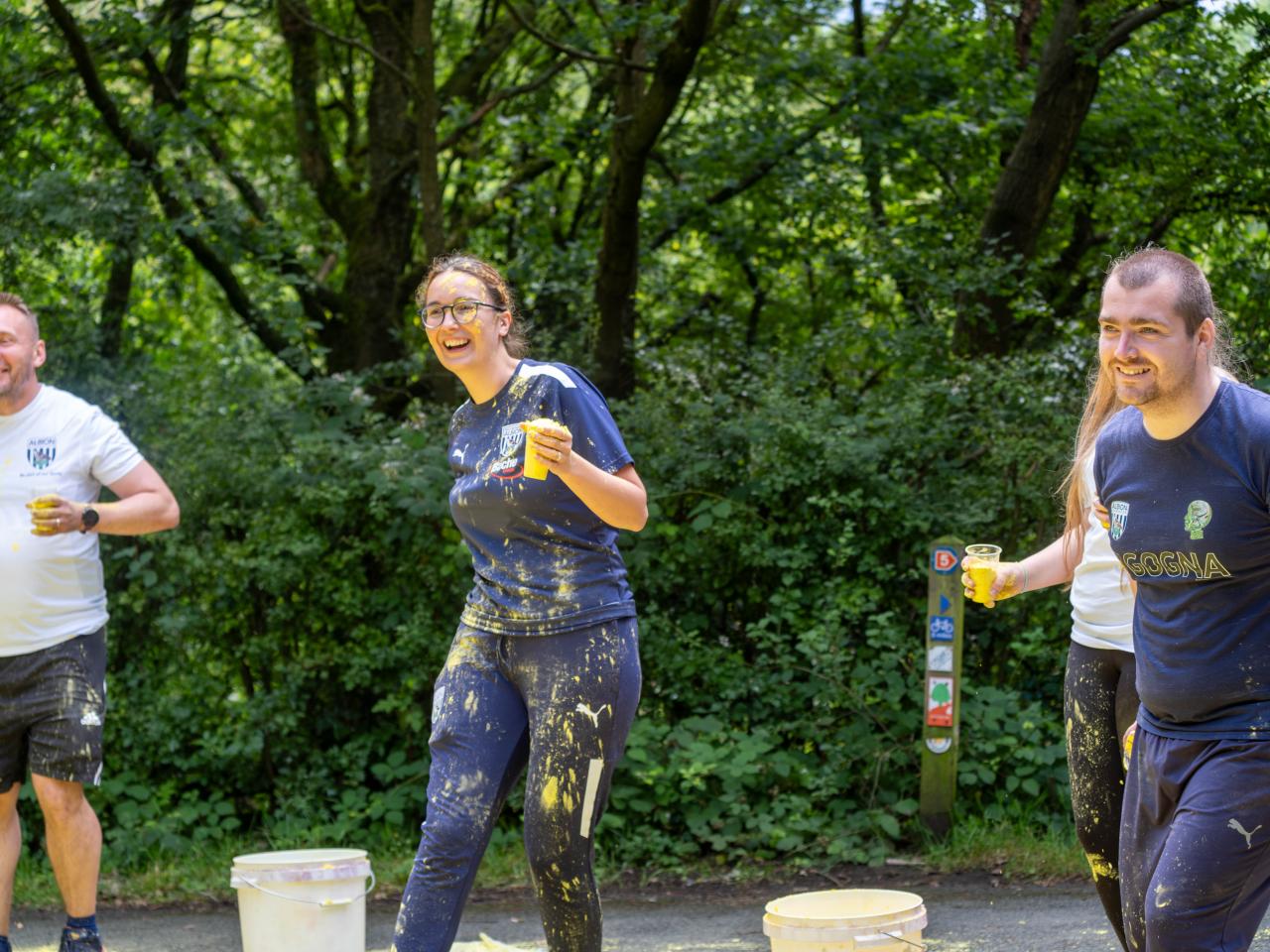Foundation staff and volunteers at the colour station, ready to throw paint powder.