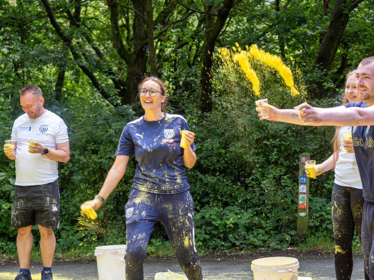 Foundation staff and volunteers at the colour station, throwing paint powder.