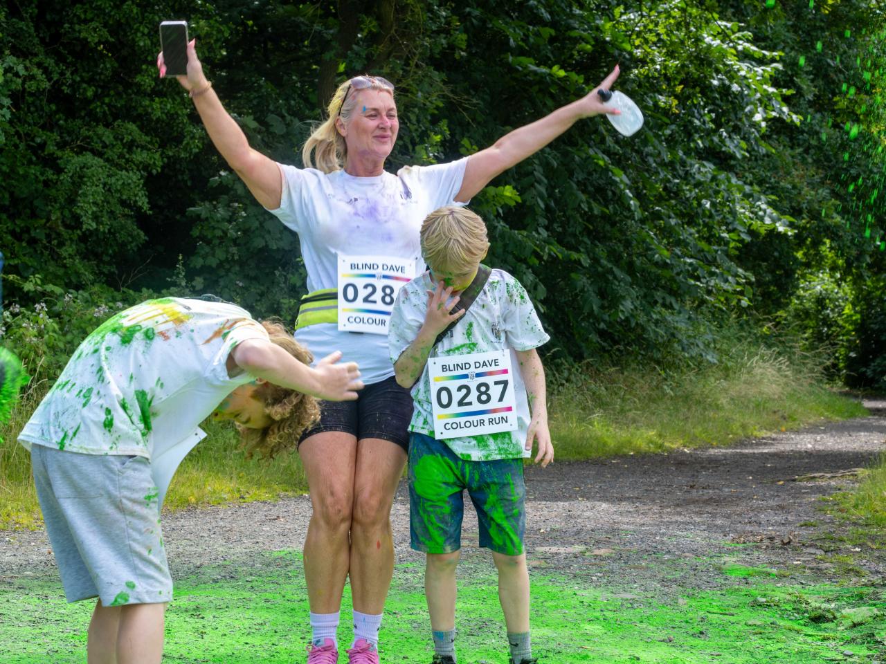 Family of three, being cover with paint powder.