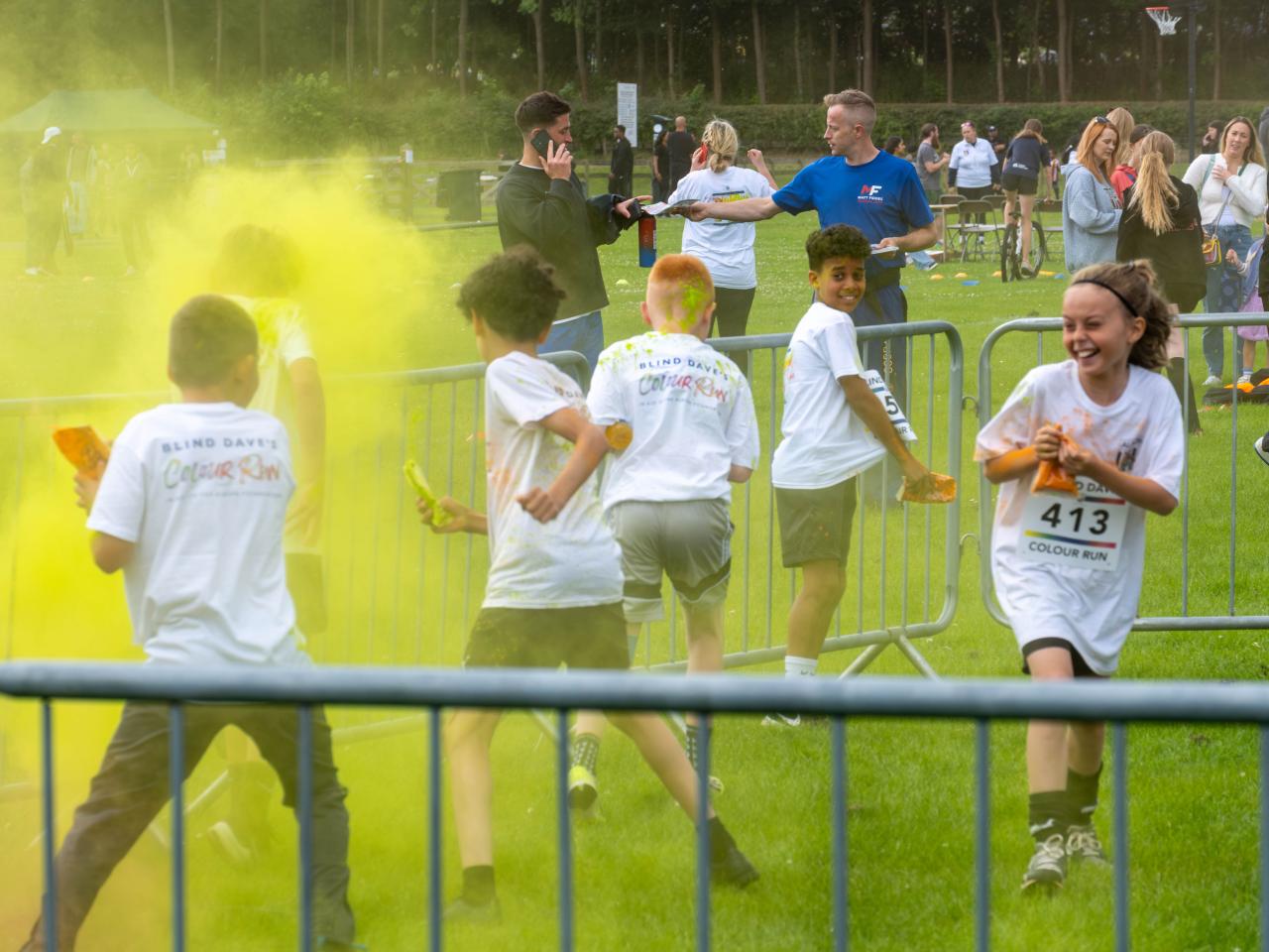 MJPL teammates throwing yellow paint powder.