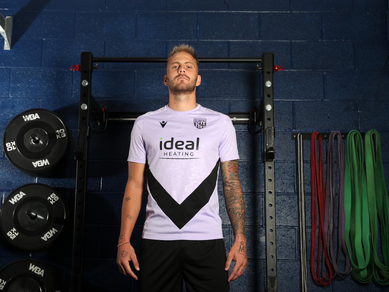 Uroš Račić staring at the camera while stood in the gym 