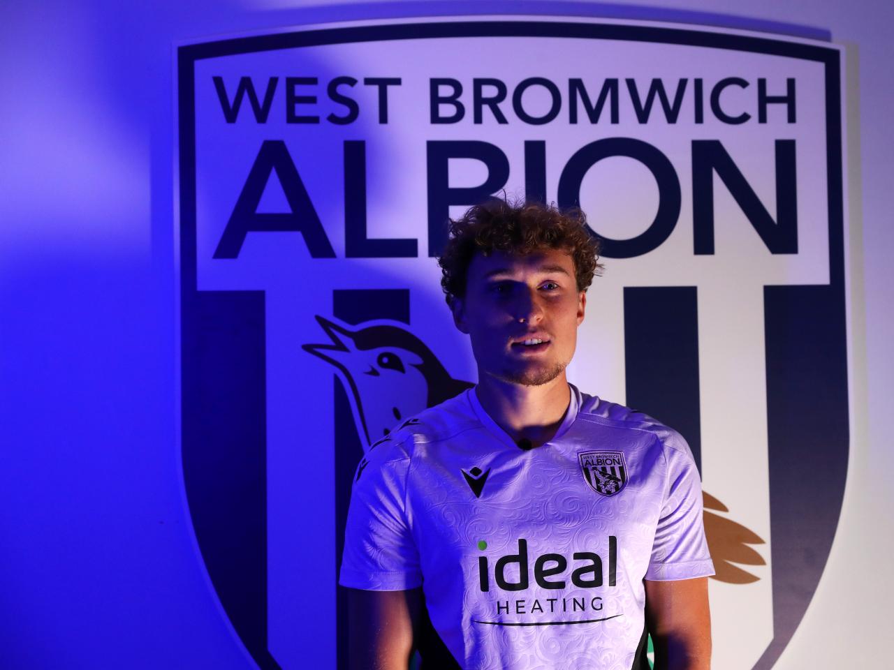 Callum Styles stood in front of a WBA badge 