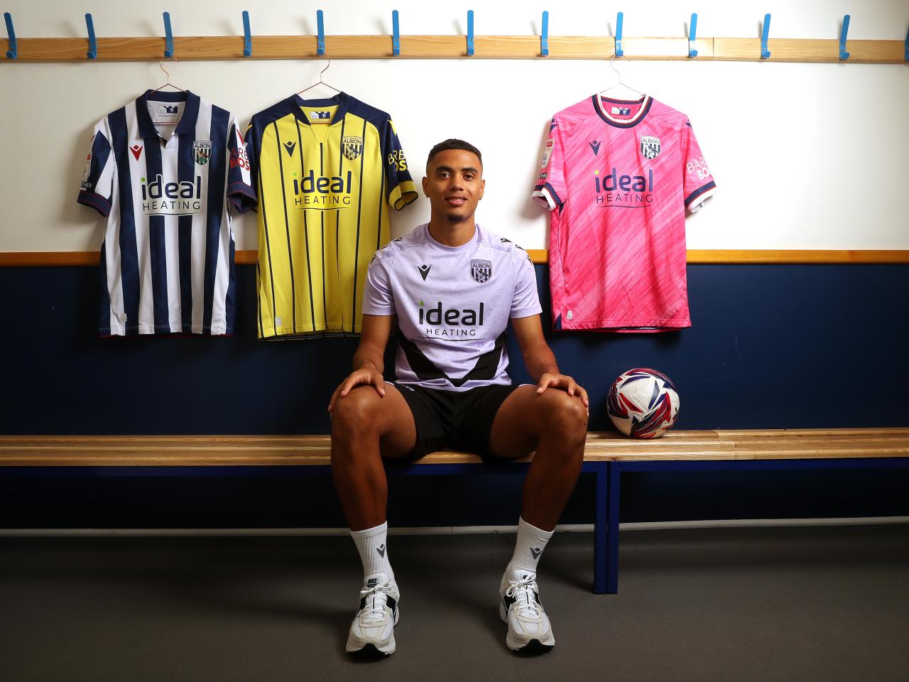 Lewis Dobbin sat in a dressing room surrounded by WBA shirts 