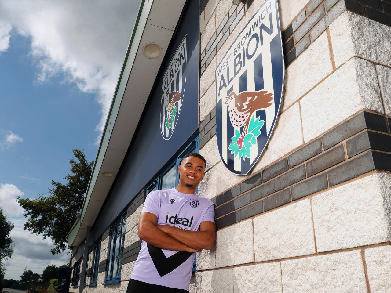 Lewis Dobbin smiling at the camera while stood outside the training ground 