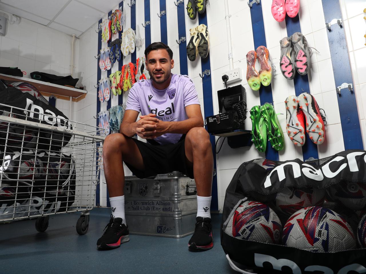 Gianluca Frabotta smiling at the camera while sat in the boot room