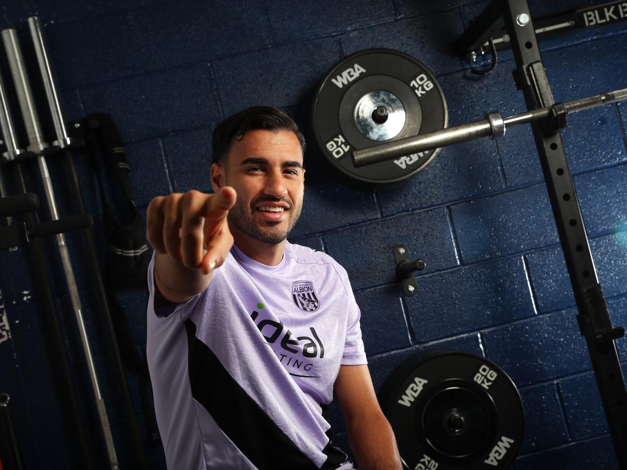 Gianluca Frabotta smiling at the camera while sat in the gym