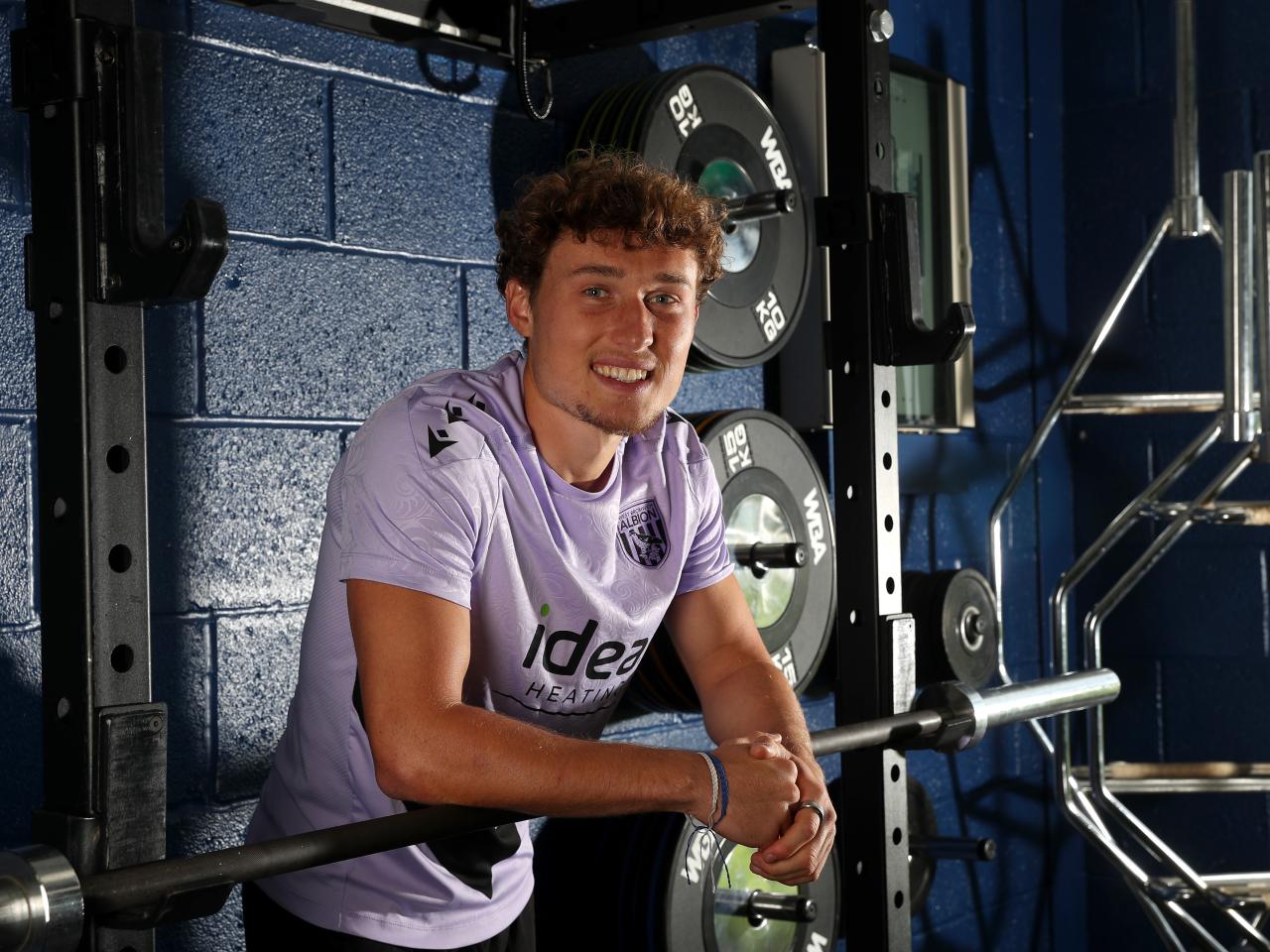 Callum Styles smiling at the camera while stood in the gym