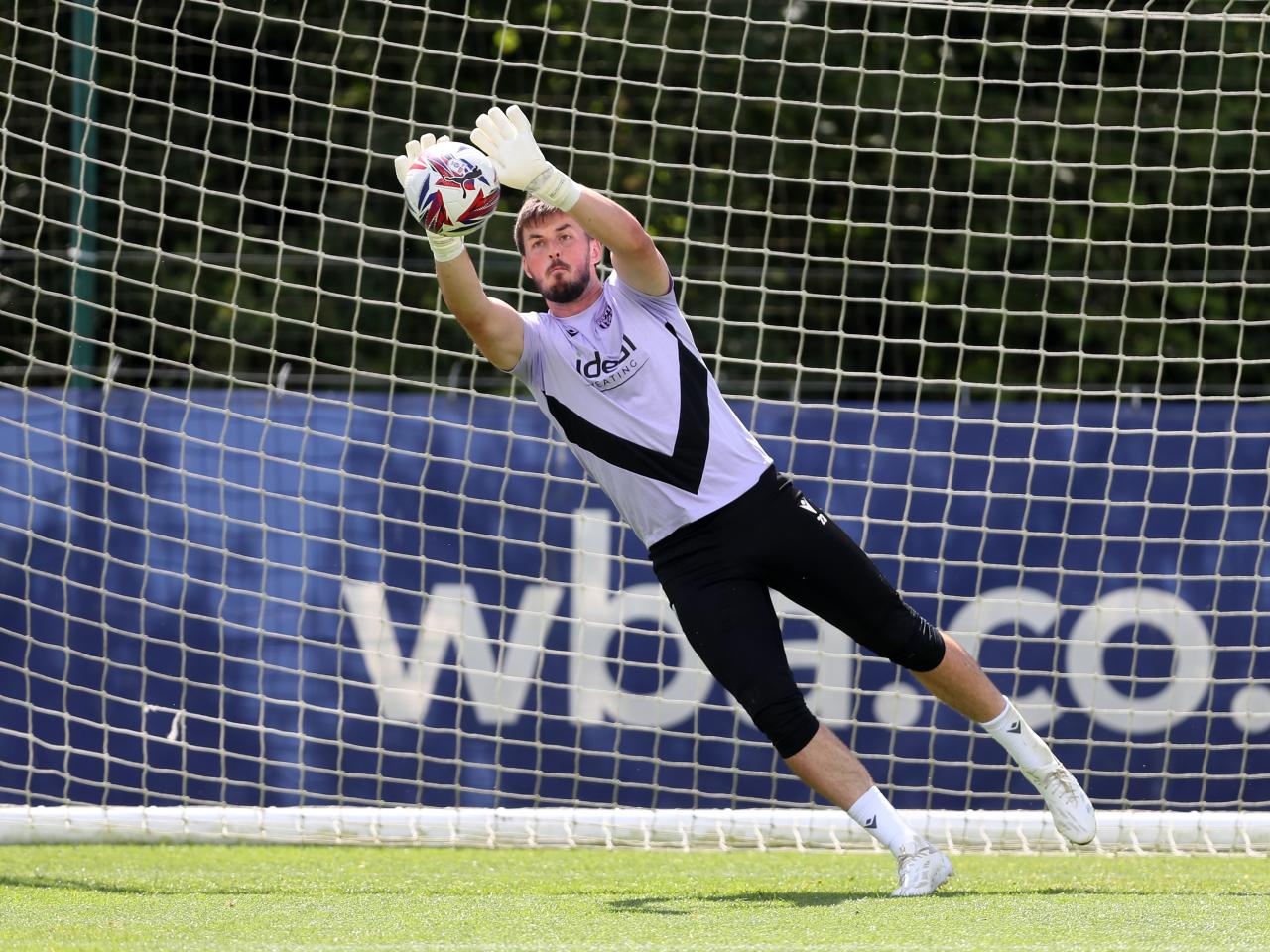 Joe Wildsmith diving to catch a ball during training 