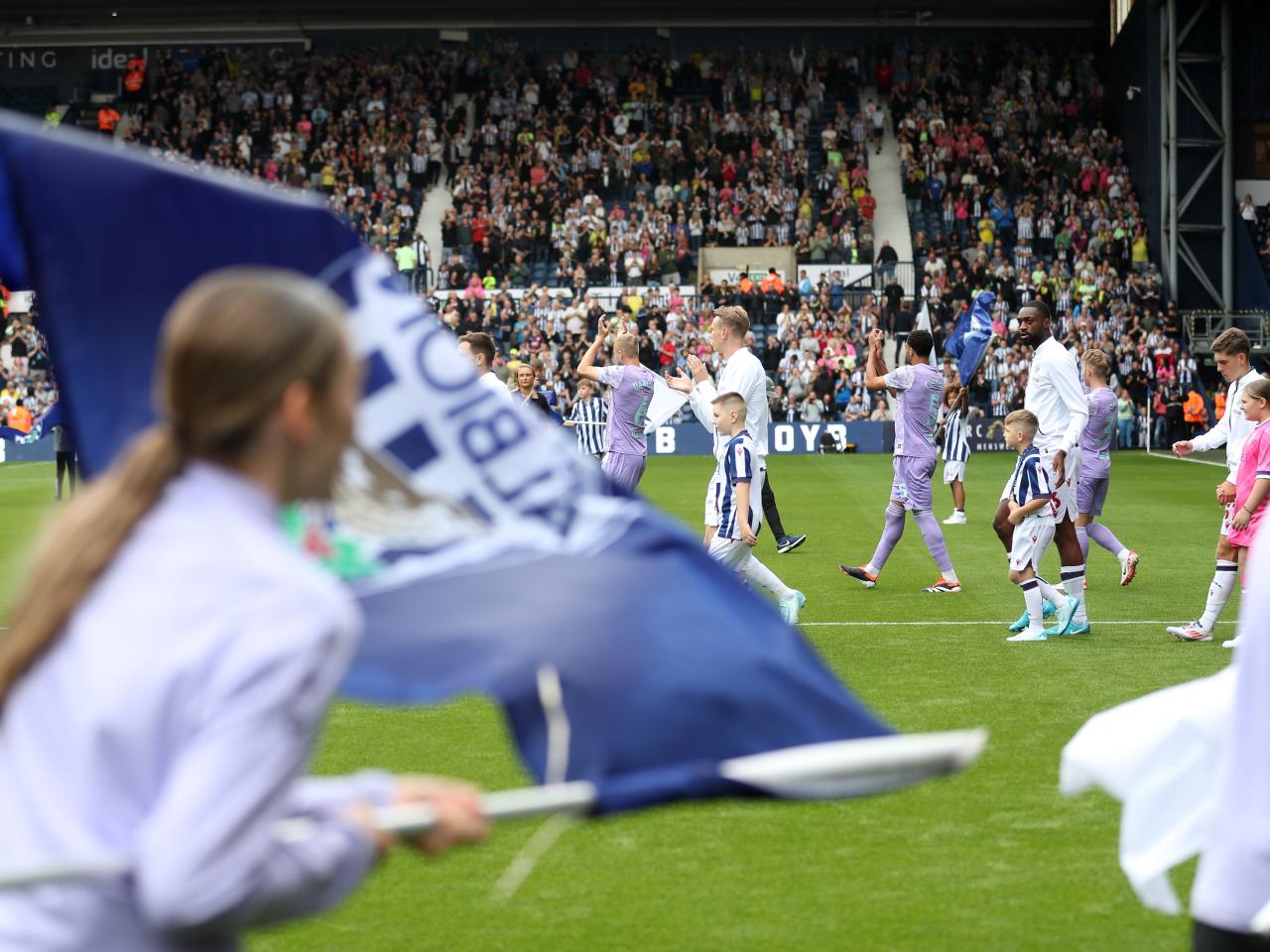 Albion players walk out at The Hawthorns with flags around them