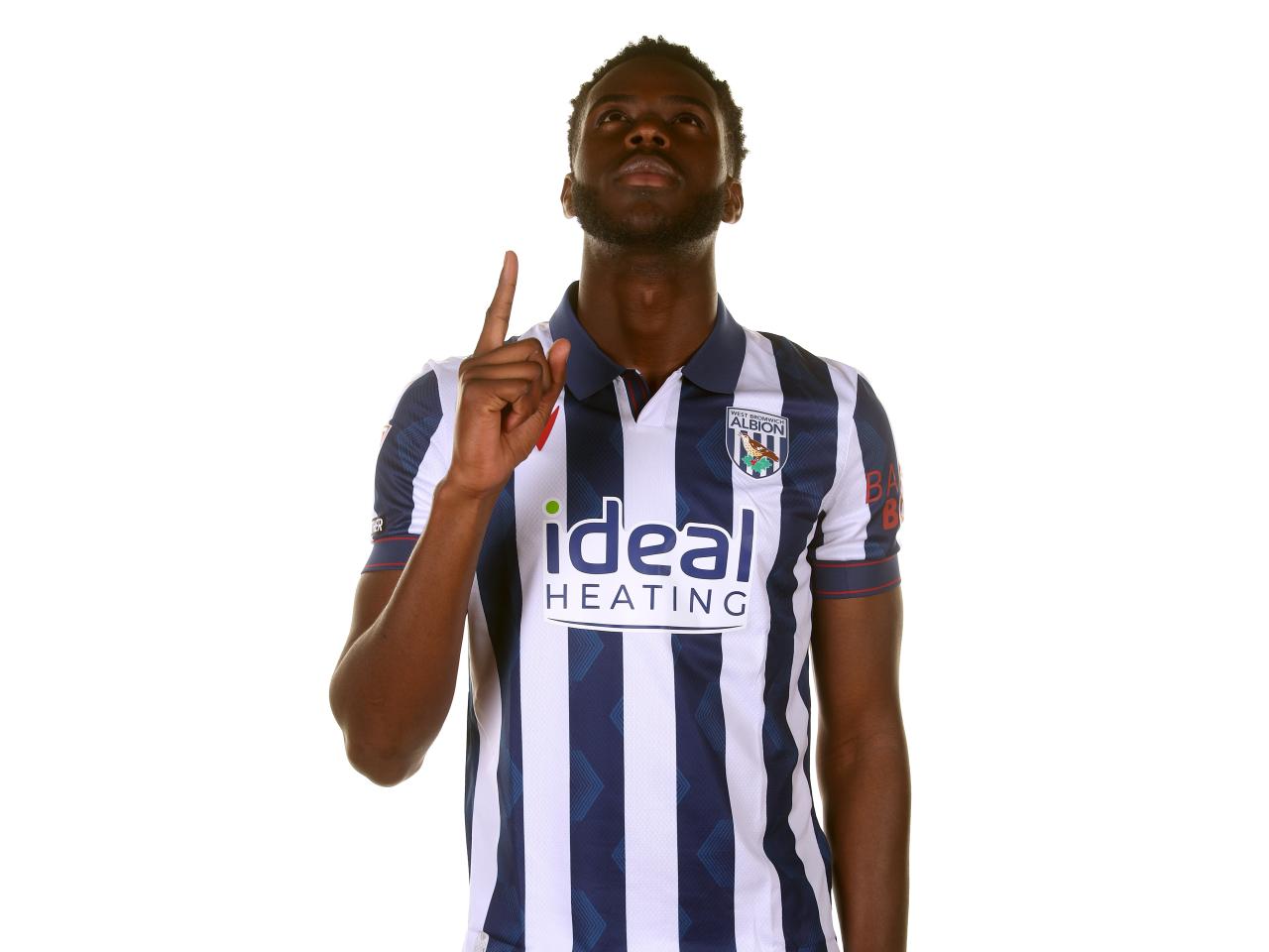 Mo Faal wearing the home shirt pointing to the sky 