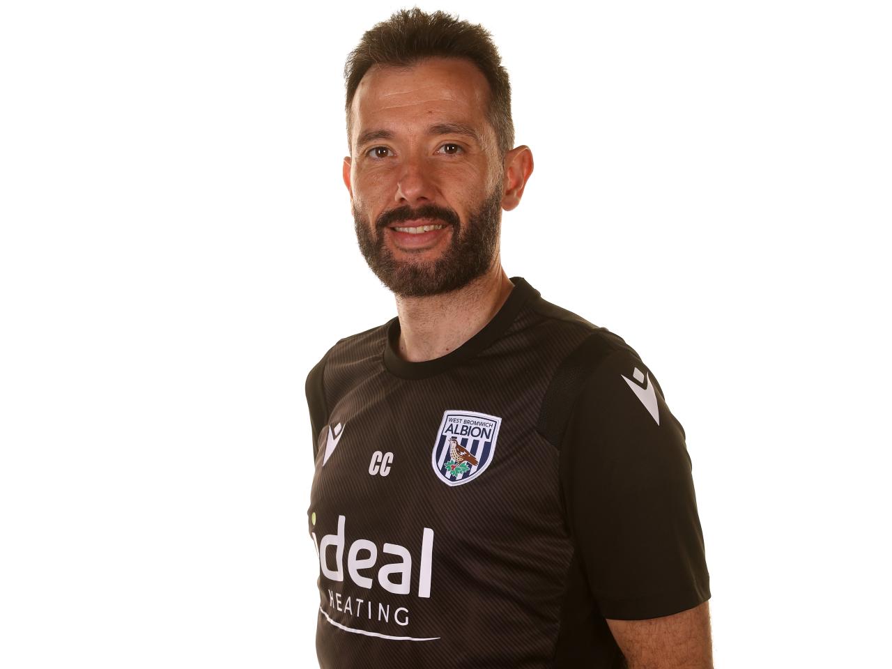 Albion head coach Carlos Corberán smiling at the camera 