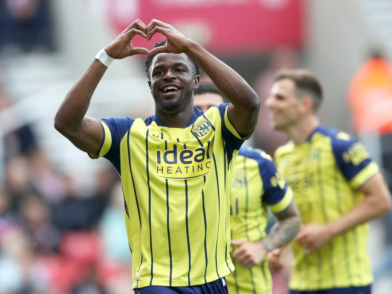 A photo of Albion players in the yellow and blue 2024/25 away kit against Stoke City