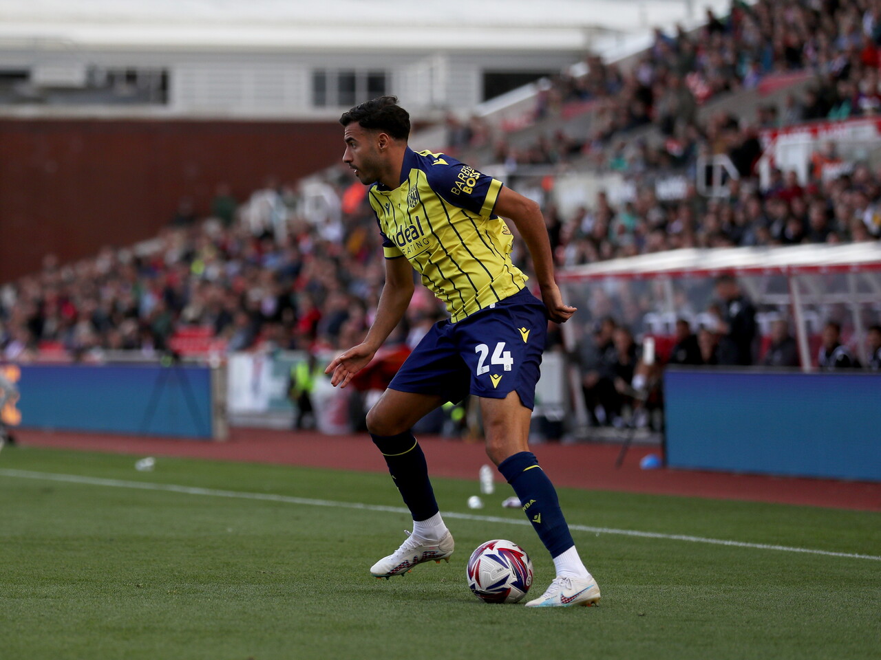 A photo of Albion players in the yellow and blue 2024/25 away kit against Stoke City