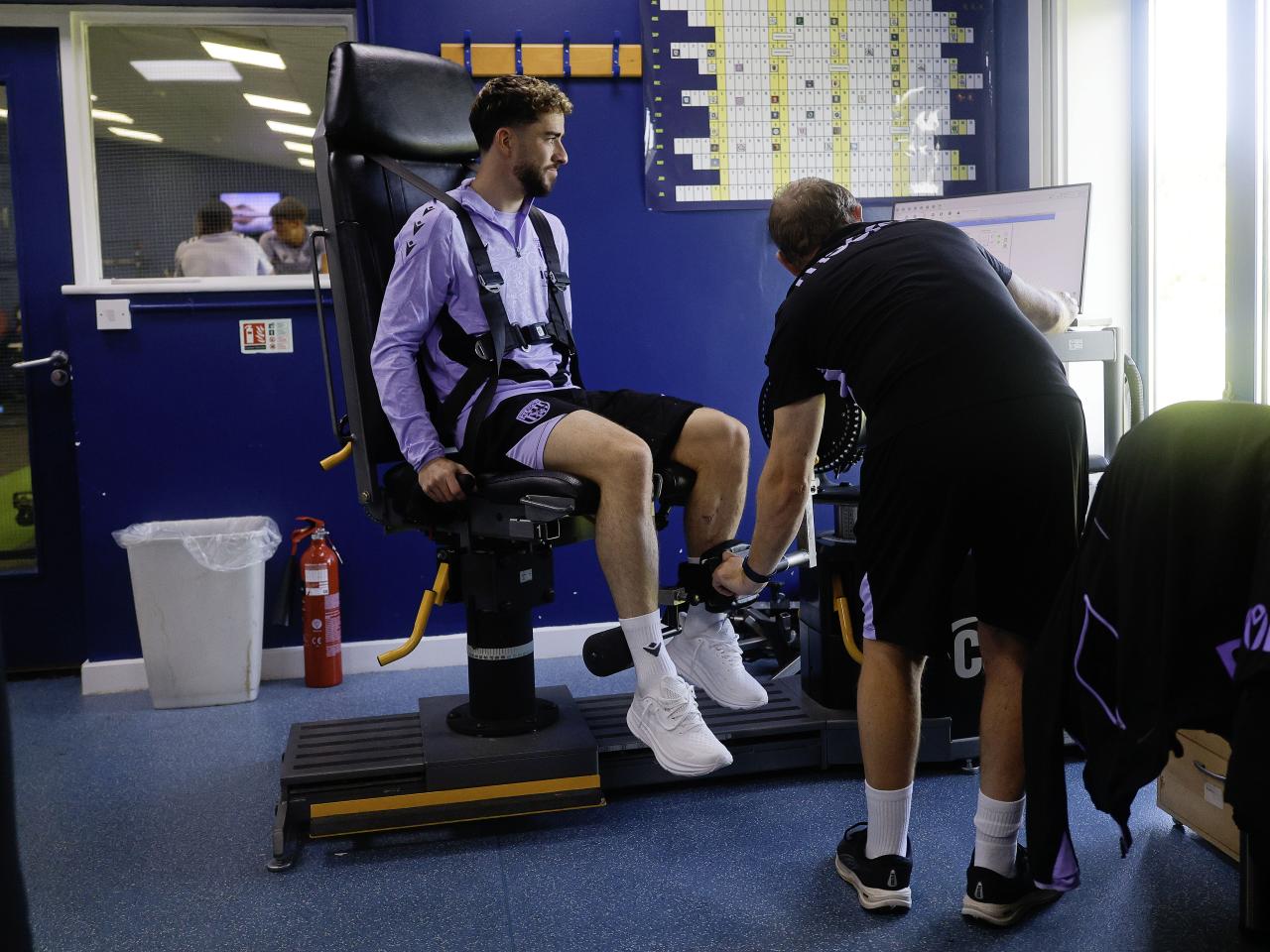 Mikey Johnston sat in a medical chair going through tests with a member of staff