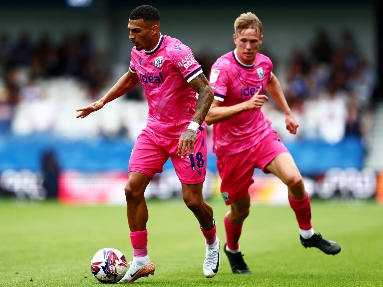 Karlan Grant on the ball at QPR with Torbjørn Heggem behind him 