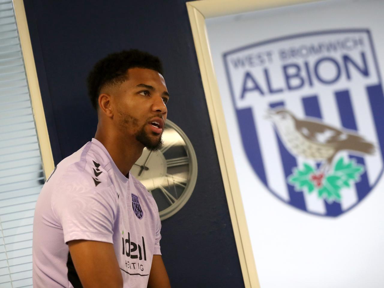 Mason Holgate next to a big WBA badge 