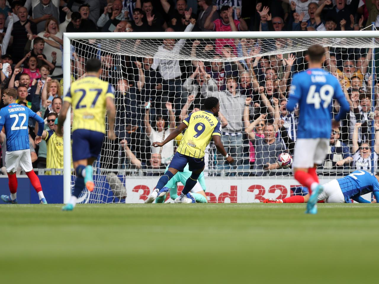 Albion in action against Portsmouth at Fratton Park, in yellow and blue away colours.